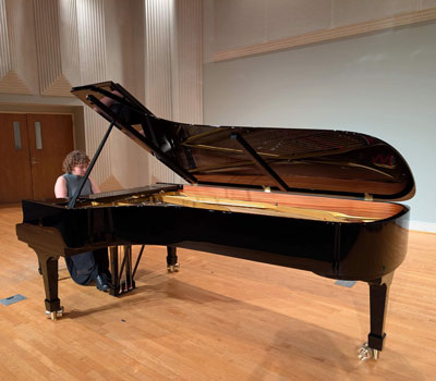 Murray State student playing on a Steinway grand piano